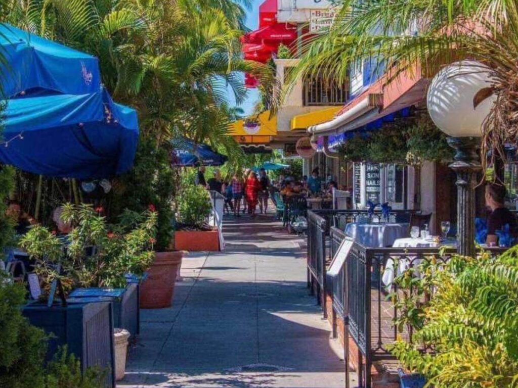 Walking through St. Armands Circle in Sarasota with shops and outdoor seating