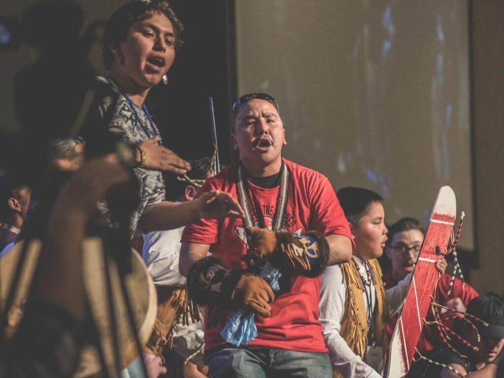 Alaska Native dancers performing inside the cultural hall at the Heritage Center