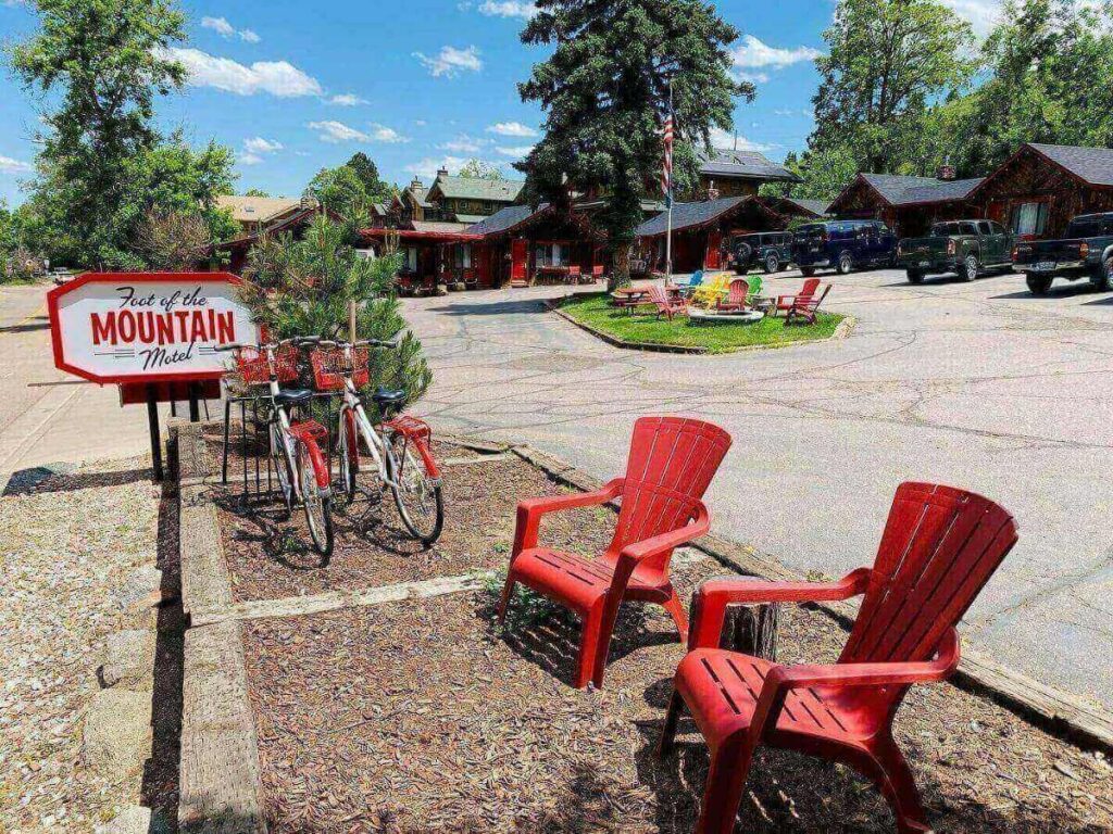 Cyclists riding along Boulder Creek Path with trees and water.