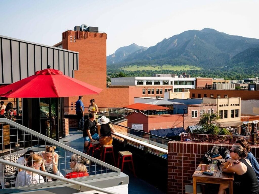 People walking along the shaded Boulder Creek Path in summer.