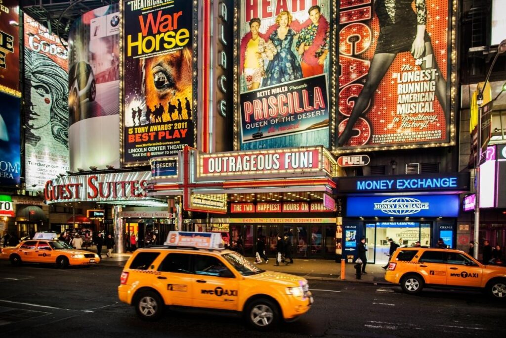 Broadway theater marquee lit up at night in NYC