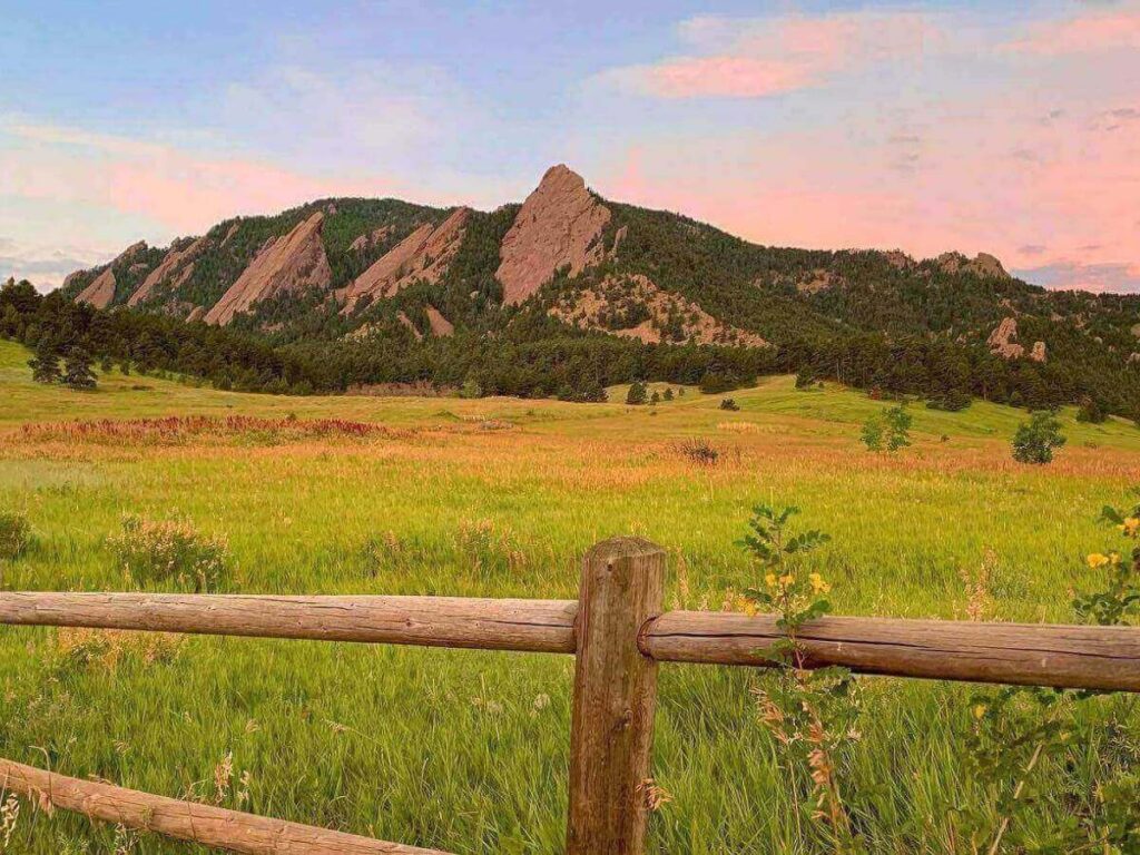 Sunrise at Chautauqua Park with people gathering before a hike.