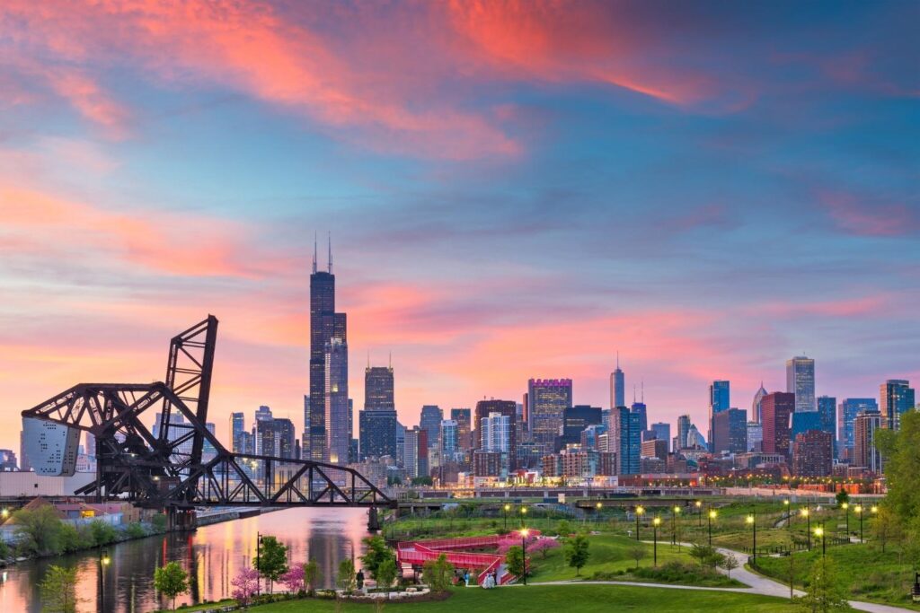 Sunset over the Chicago Riverwalk with people dining outdoors
