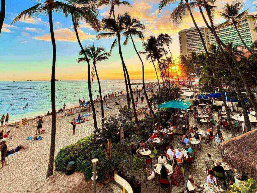 Couple walking along Waikiki Beach at sunset