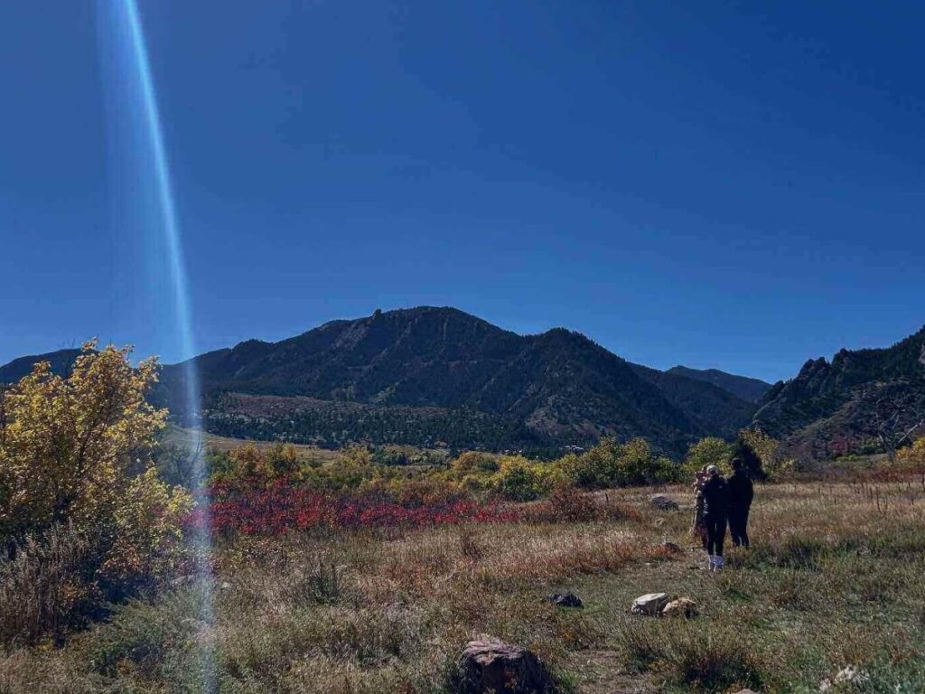 Hikers on the Flatirons Loop trail overlooking Boulder.