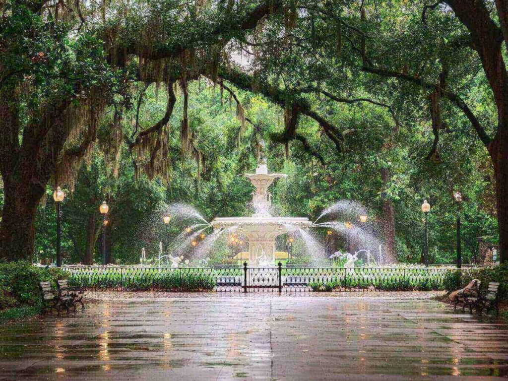 Forsyth Park fountain surrounded by greenery and locals spending a slow afternoon