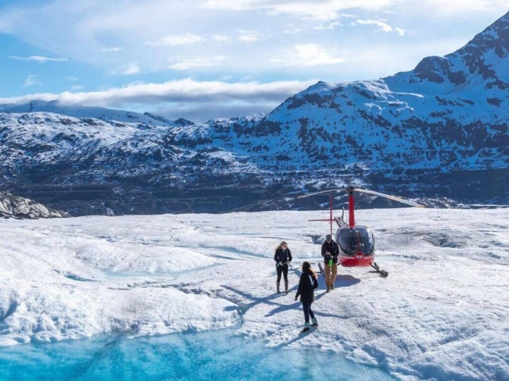Person standing on a glacier during a flightseeing tour near Anchorage