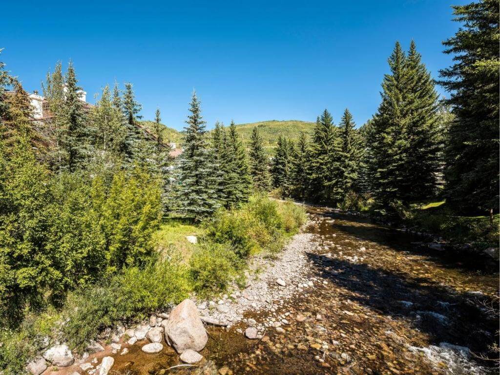 Walking path and benches along Gore Creek in Vail