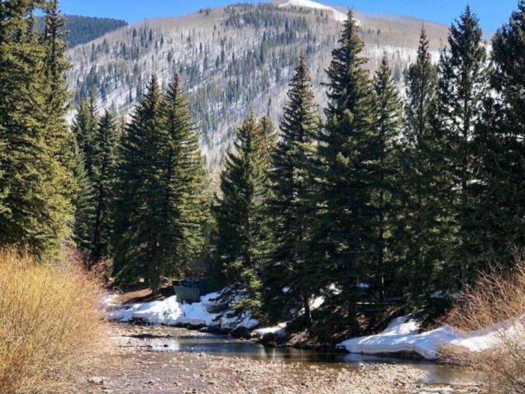 Walking path and benches along Gore Creek in Vail