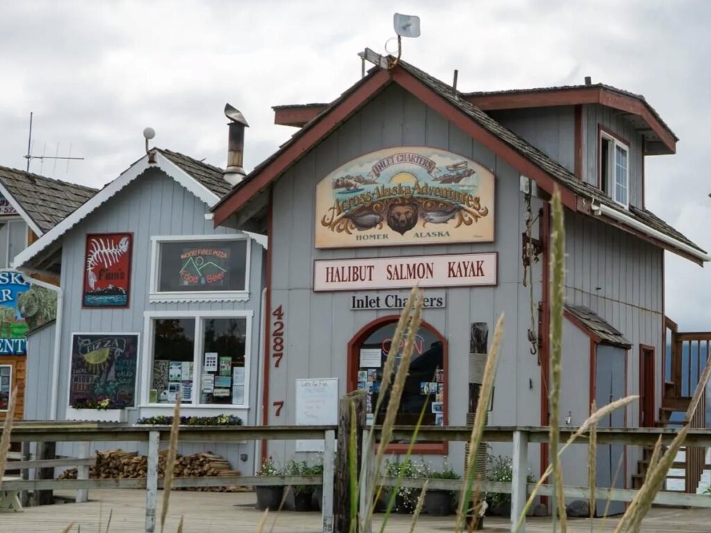 Small shops and boardwalk along the Homer Spit on a clear summer day
