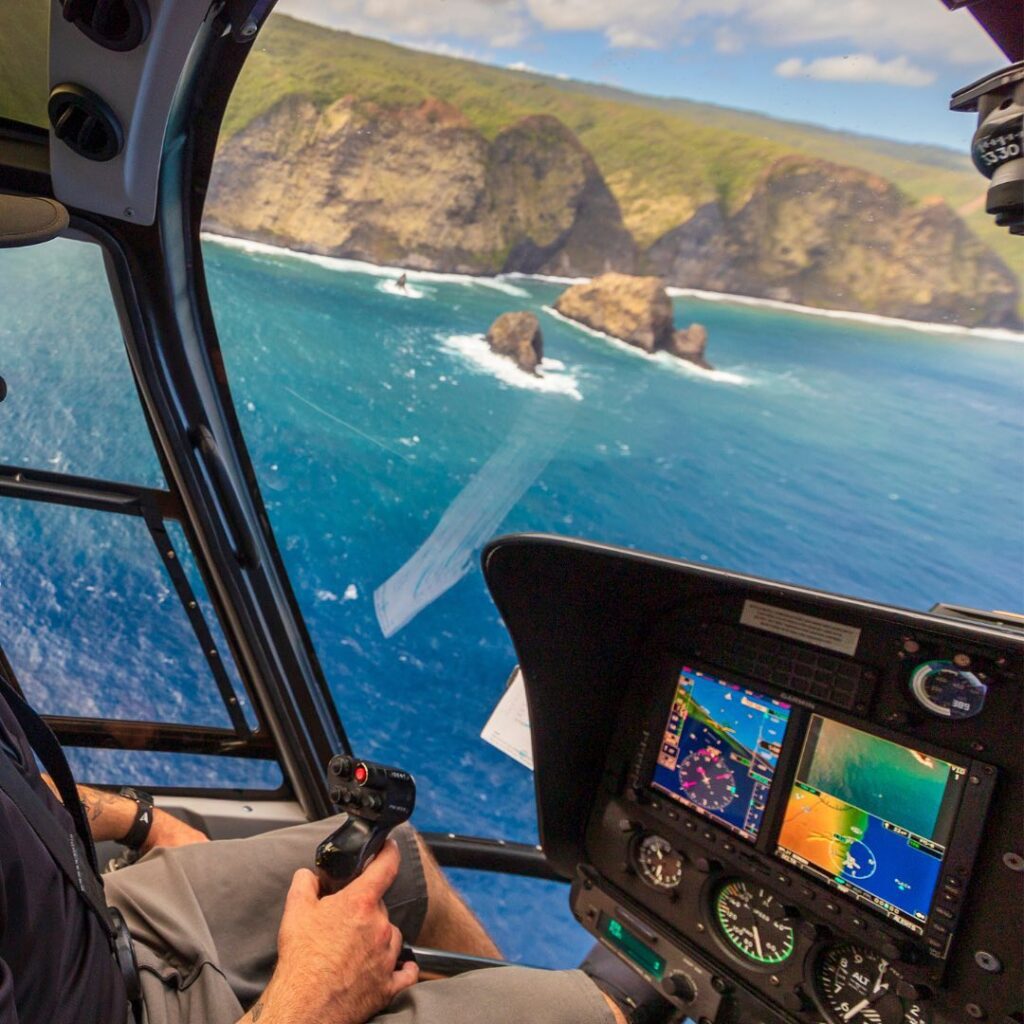 View from a helicopter flying over cliffs in Kauai