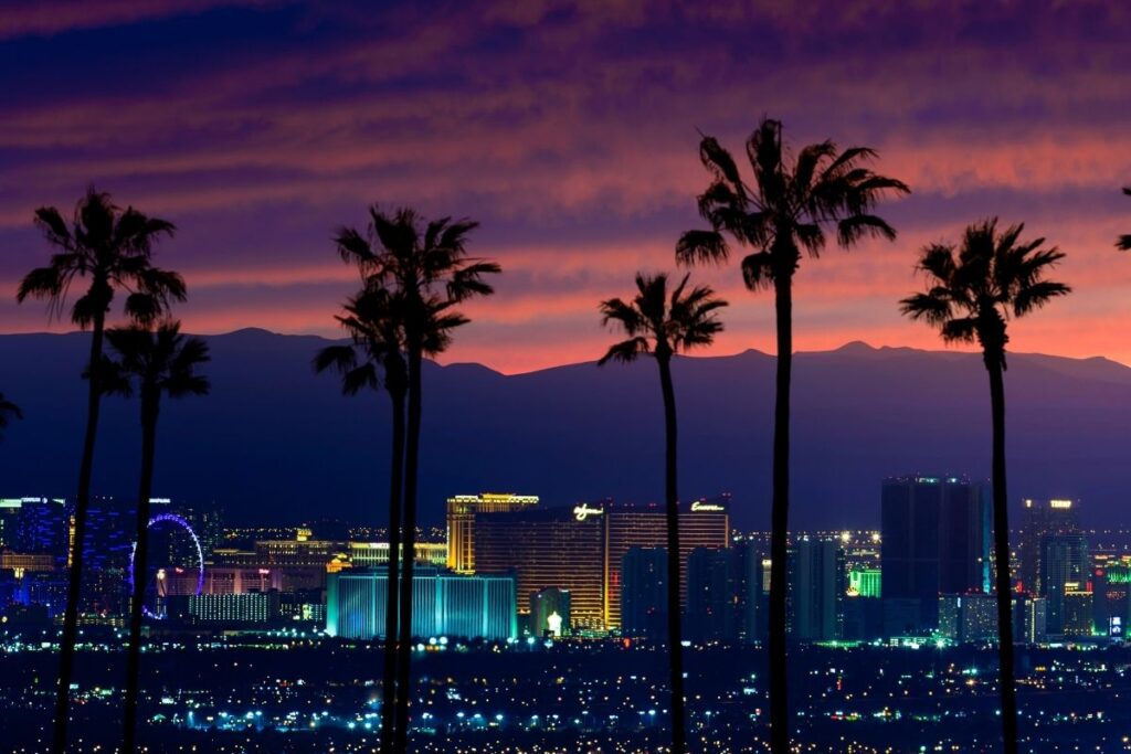 Las Vegas Strip at sunset with lights and people