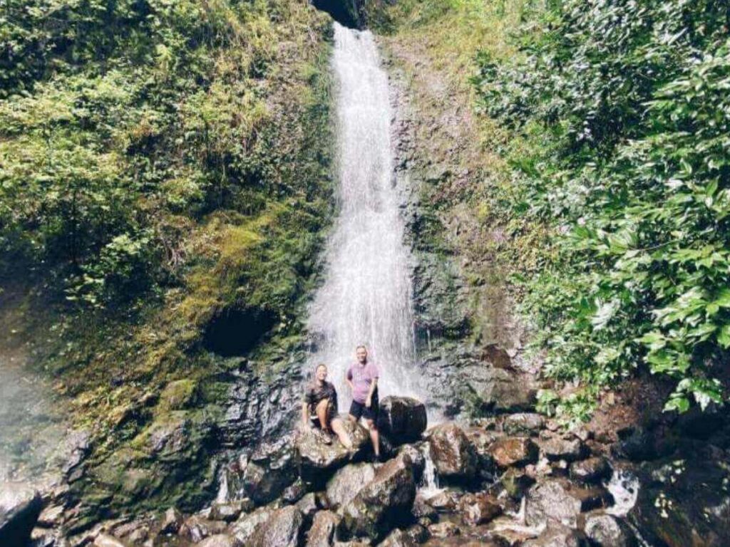 Lulumahu Falls flowing over rocky cliffs in Oahu rainforest
