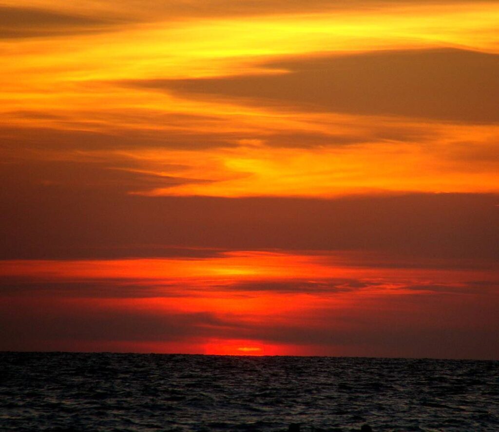 Manatee Beach at sunset with glowing sky and reflections on water
