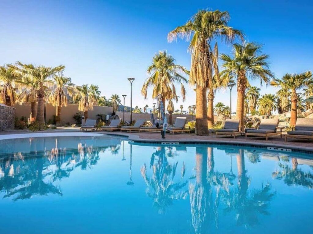 Resort pool with palm trees in Palm Springs on a sunny afternoon