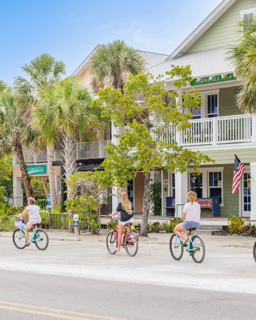 Girls biking through pine avenue