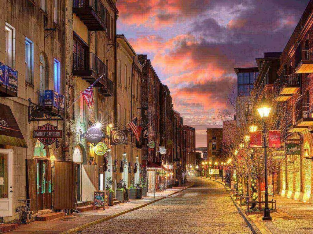 Savannah historic district at night with softly lit streets and people walking after dinner