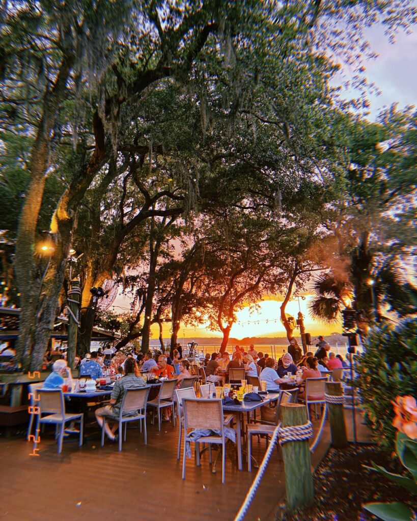 Outdoor lunch table by the water at Skull Creek Boathouse