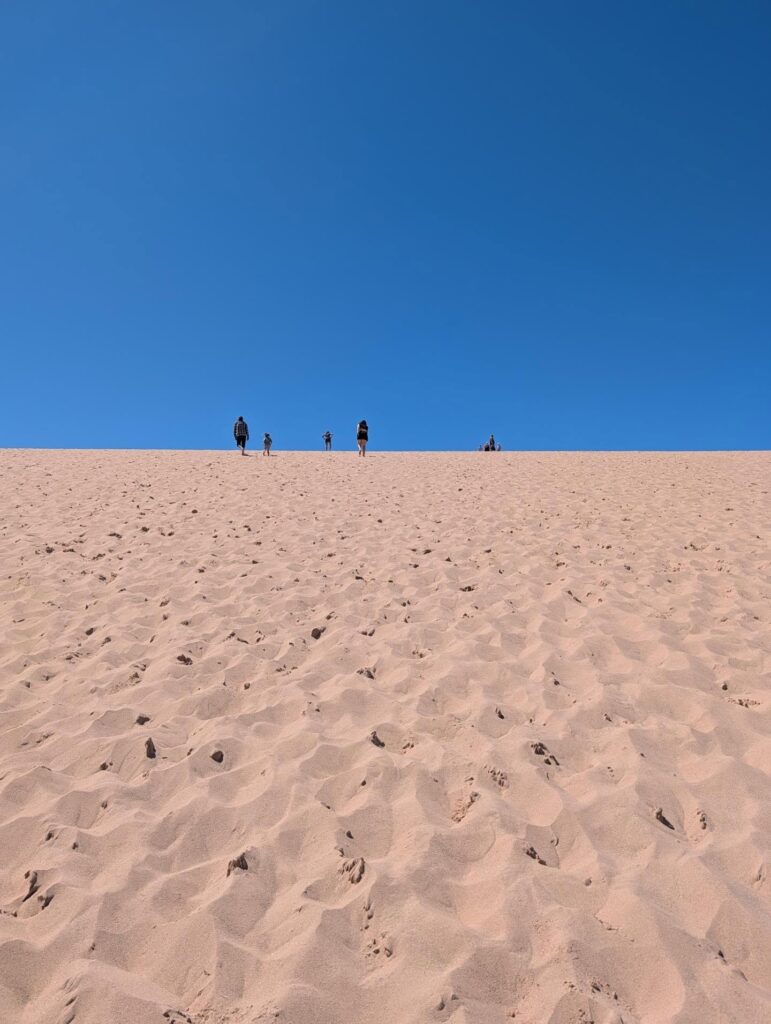 Visitors climbing the famous Dune Climb at Sleeping Bear Dunes