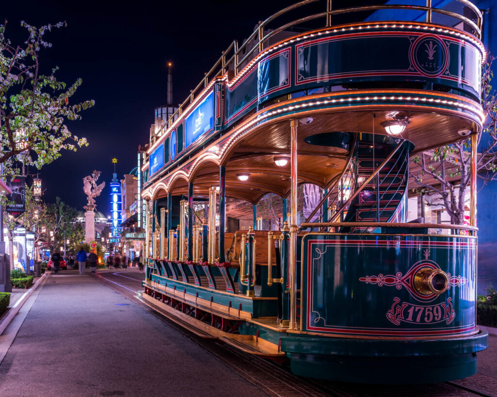 Festive outdoor view of The Grove with holiday lights and vintage trolley