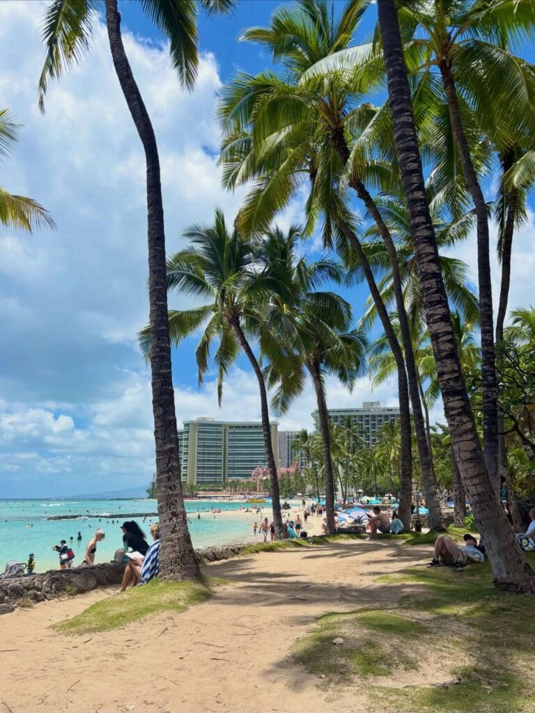 Visitors relaxing on Waikiki Beach during the afternoon
