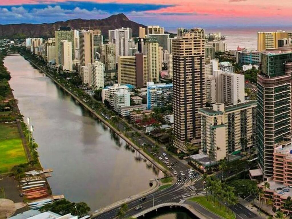 Waikiki Beach with Honolulu skyline and calm ocean water