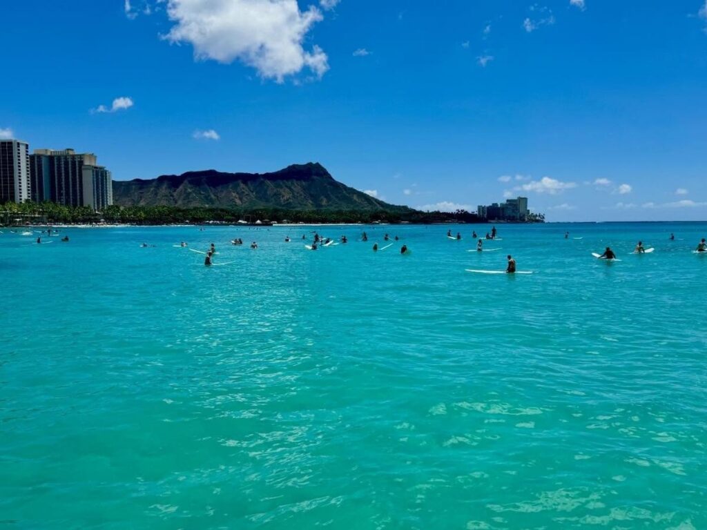 Surf lessons and visitors enjoying Waikiki Beach in Honolulu