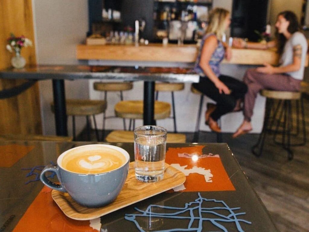People sitting with coffee in Vail Village during summer