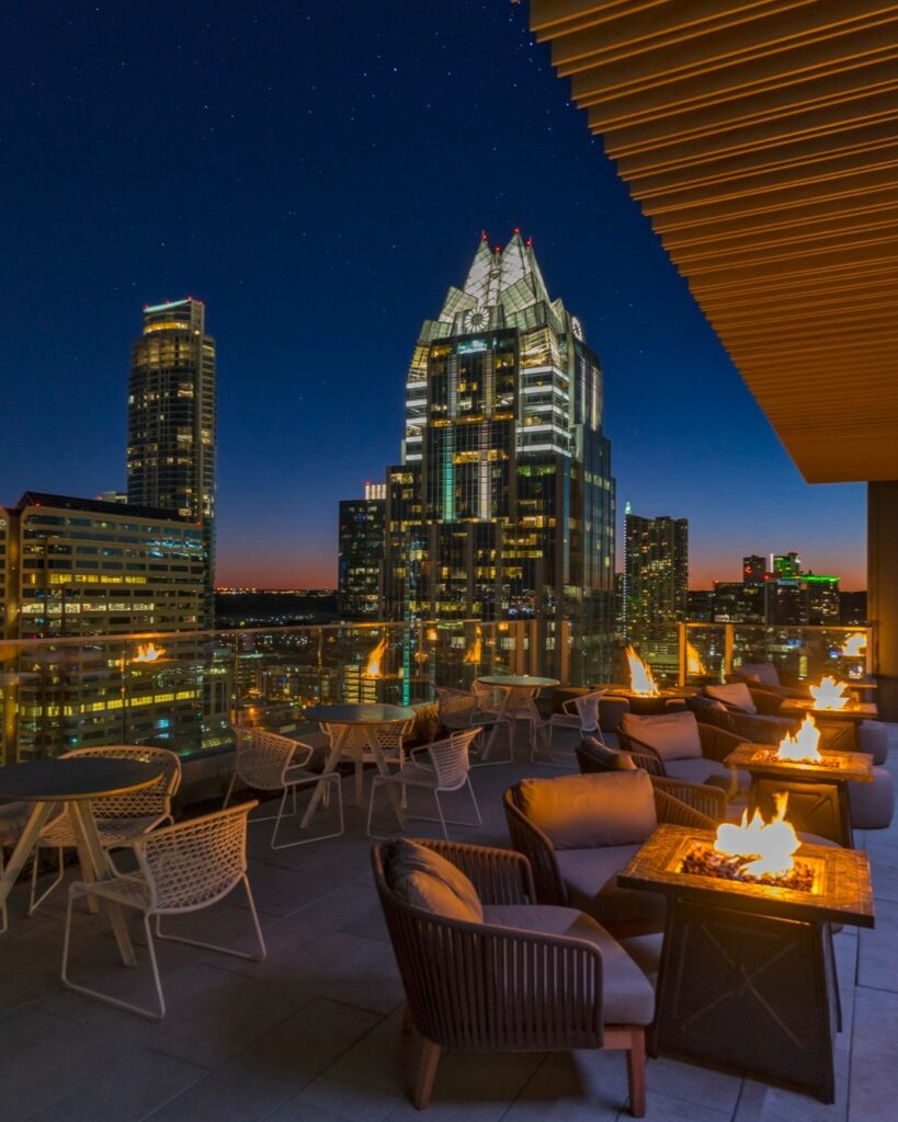 Sunset view from a rooftop bar in West Hollywood with cocktails and skyline in background