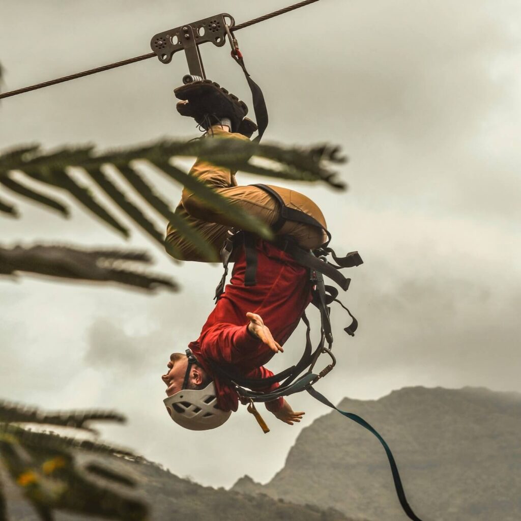  Person ziplining over green canyon in Koloa, Kauai