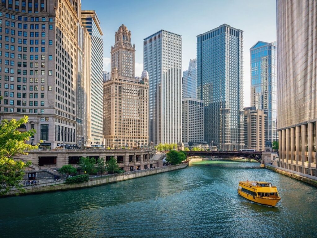 Tour boat on Chicago River with skyscrapers in the background