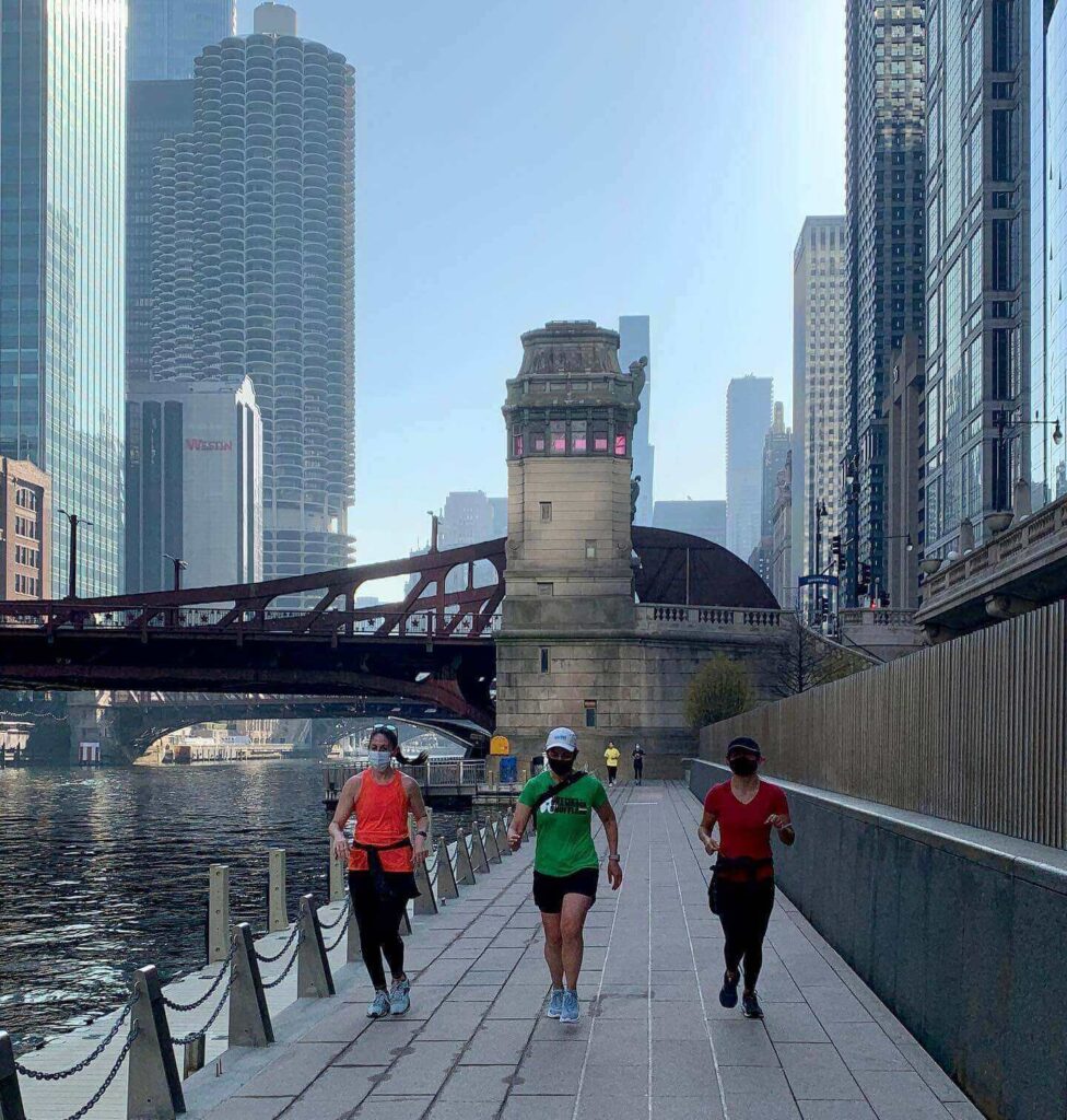 Morning view of the Chicago Riverwalk with boats and downtown skyscrapers