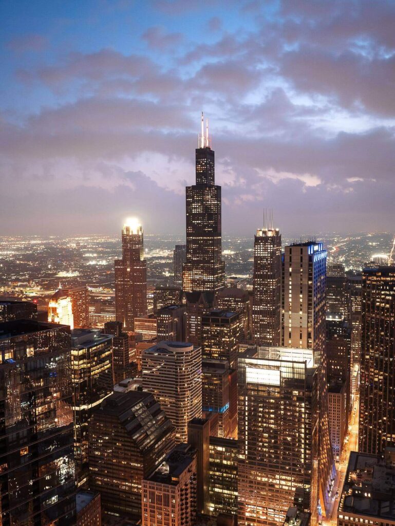 Chicago skyline illuminated at night reflecting on the Chicago River