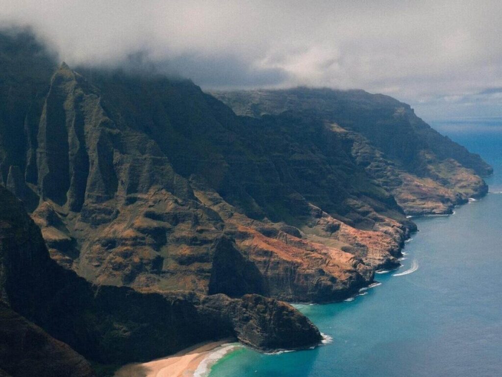 Ke’e Beach at Hāʻena State Park with green cliffs on the North Shore