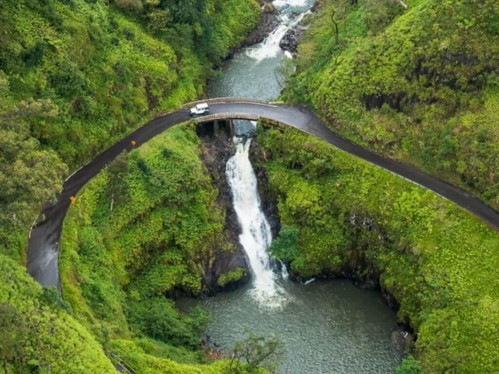 Hana Bay on Maui with lush green cliffs and calm water