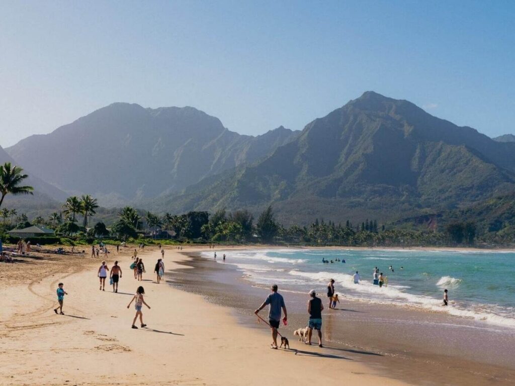Hanalei Bay on Kauai with green mountains rising behind the beach