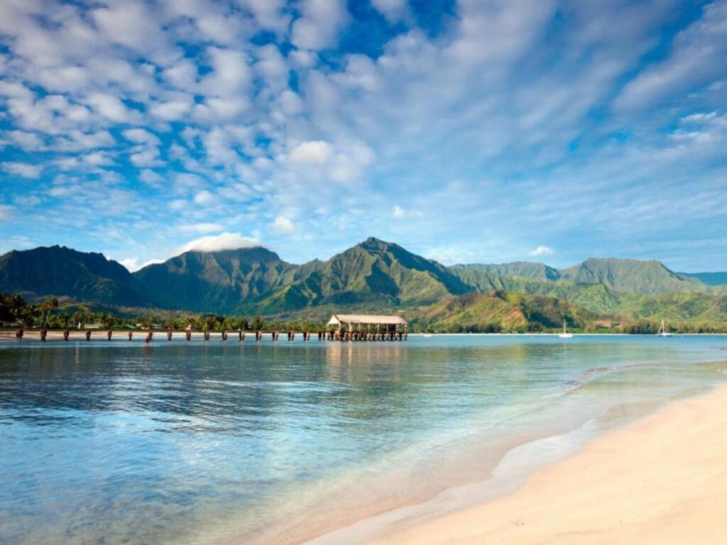 Hanalei Bay beach with green mountains on Kauai North Shore