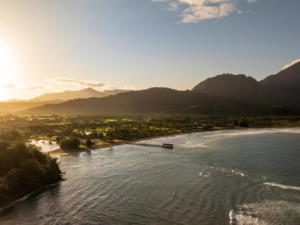 Hanalei Bay beach with green mountains on Kauai North Shore