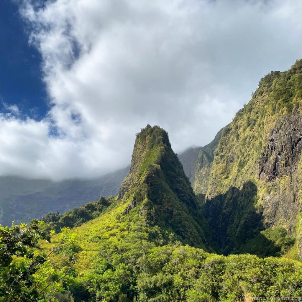 The ʻĪao Needle rising from the misty, green-covered valley of ʻĪao State Monument