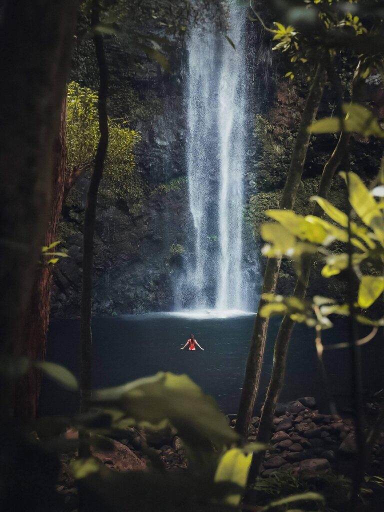 Wailua Falls flowing through lush green rainforest during spring on Kauai