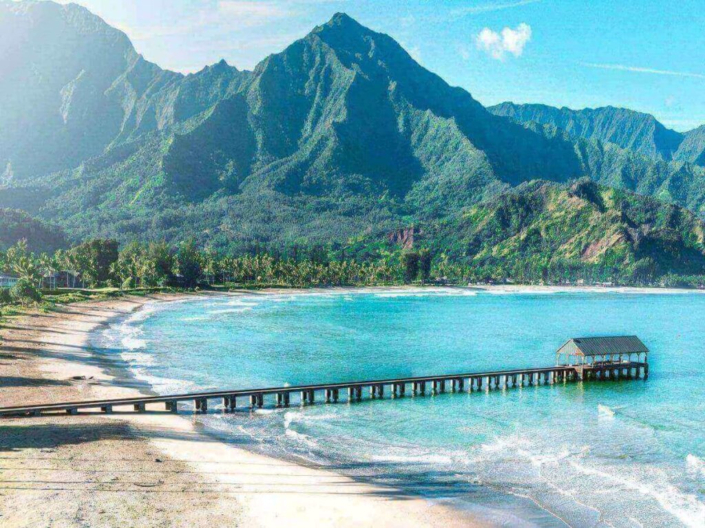 Kaunakakai Wharf extending into calm ocean at sunset on Molokai