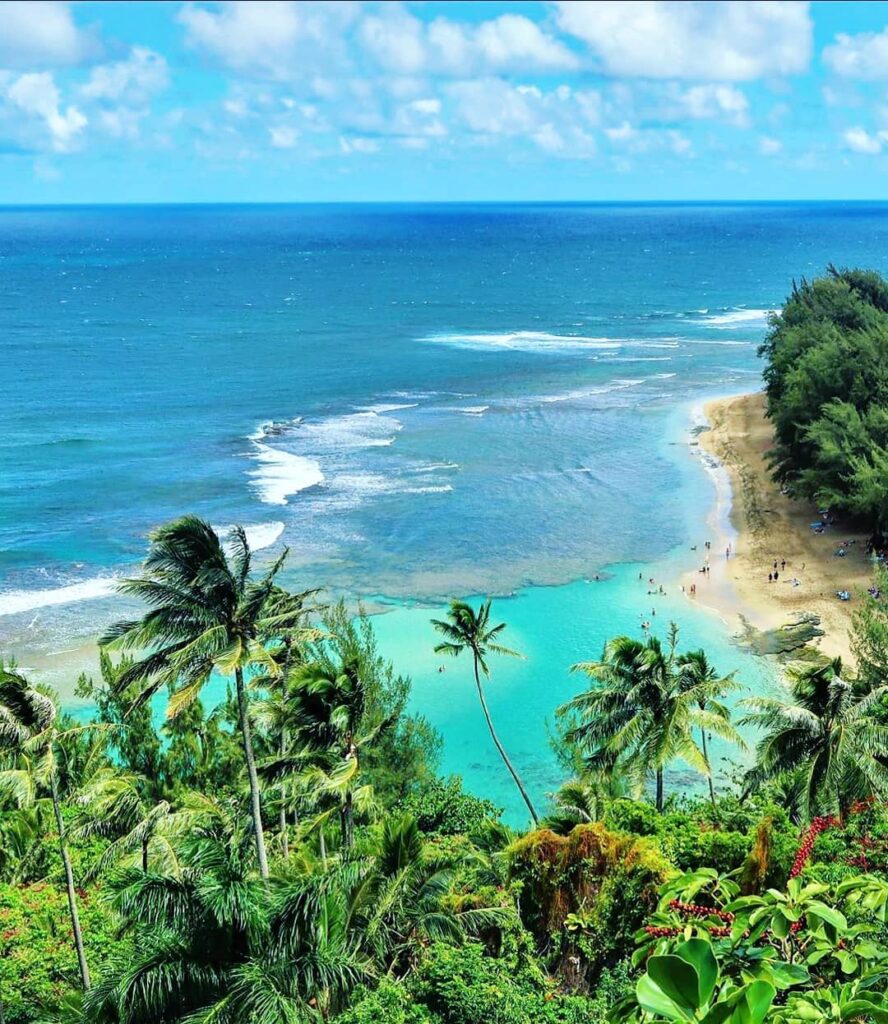 Clear lagoon and lush mountains at Ke'e Beach on Kauai's North Shore