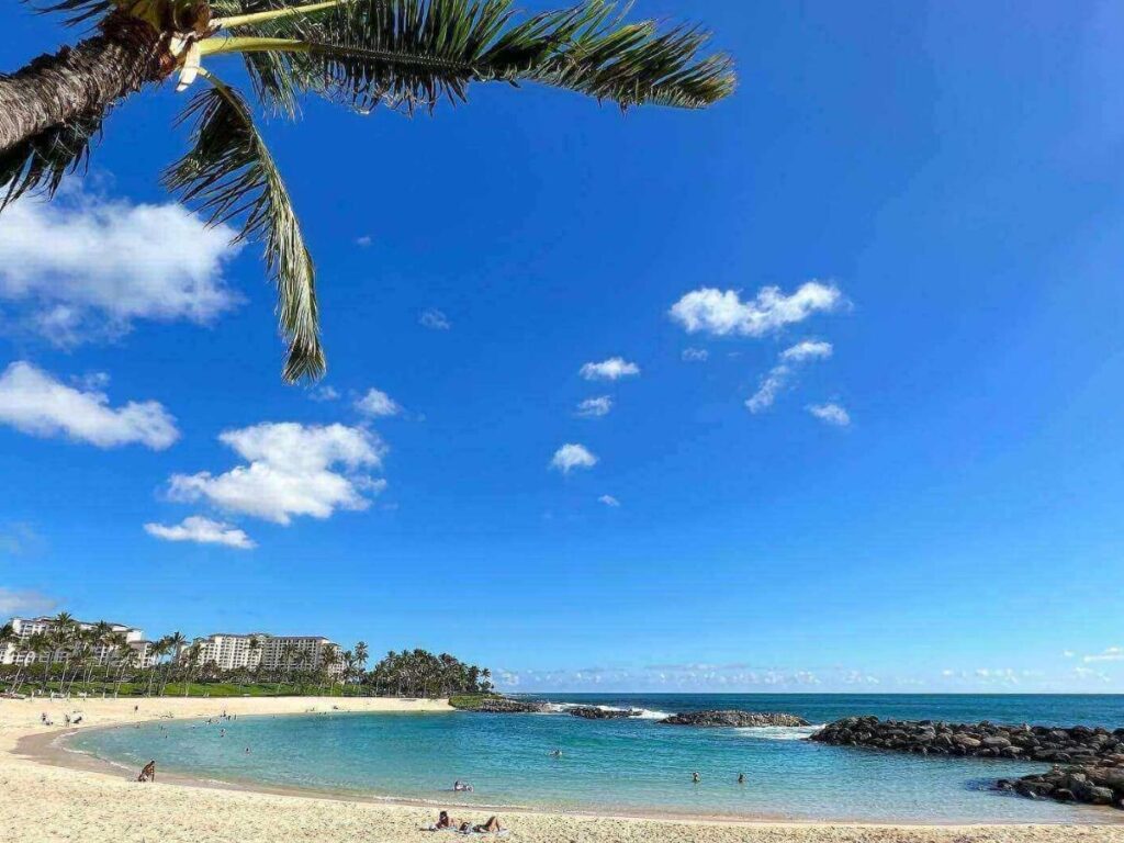 Calm protected lagoon at Ko Olina in Oahu with clear water and palm trees