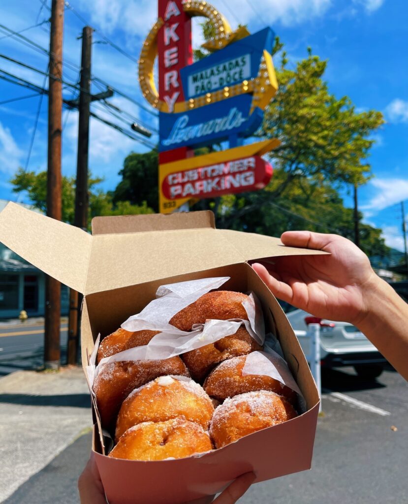 Sugar-dusted malasadas in paper box from Leonard’s Bakery in Honolulu