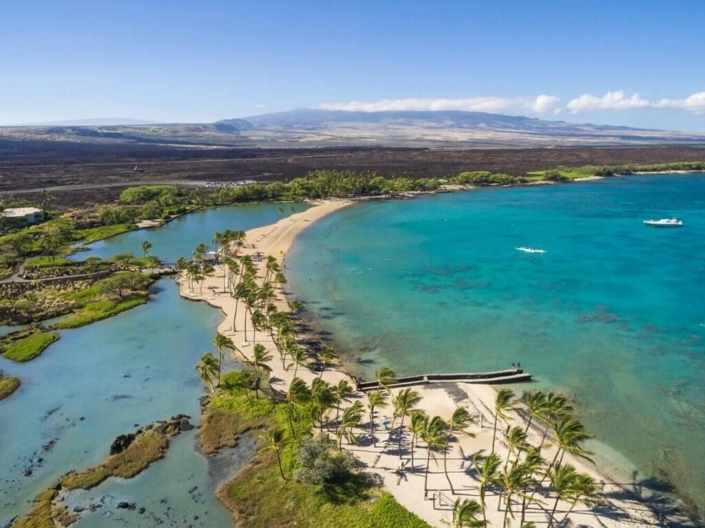 Crescent-shaped Mauna Kea Beach with calm clear water on the Big Island
