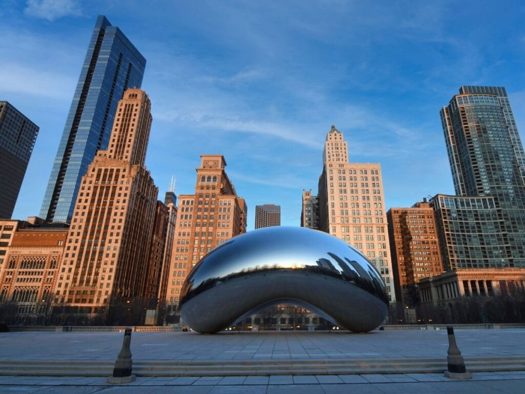 Cloud Gate sculpture reflecting Chicago skyline in Millennium Park