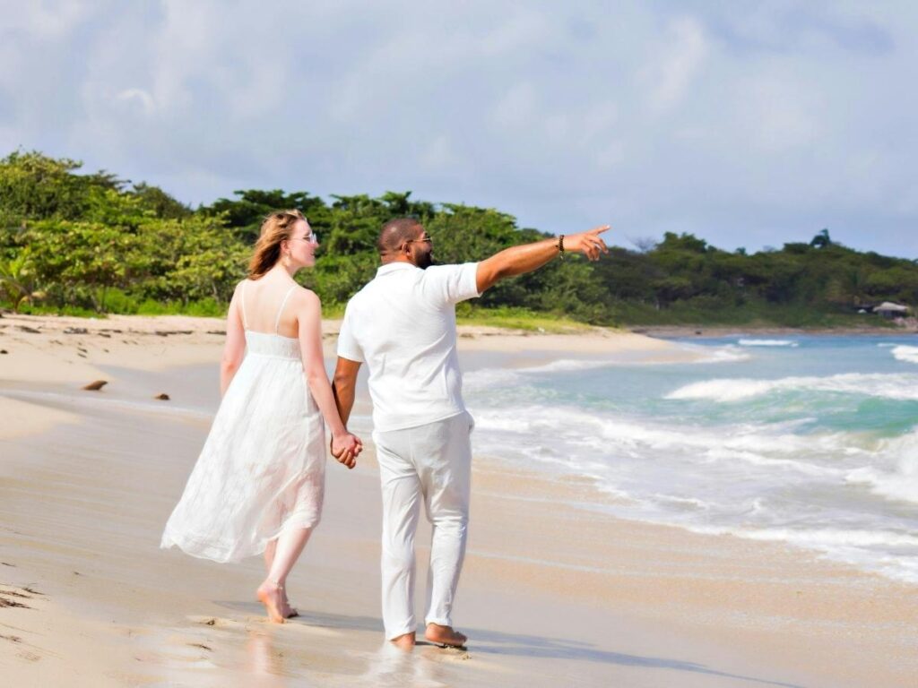 Couple walking along a quiet beach on Molokai at sunset