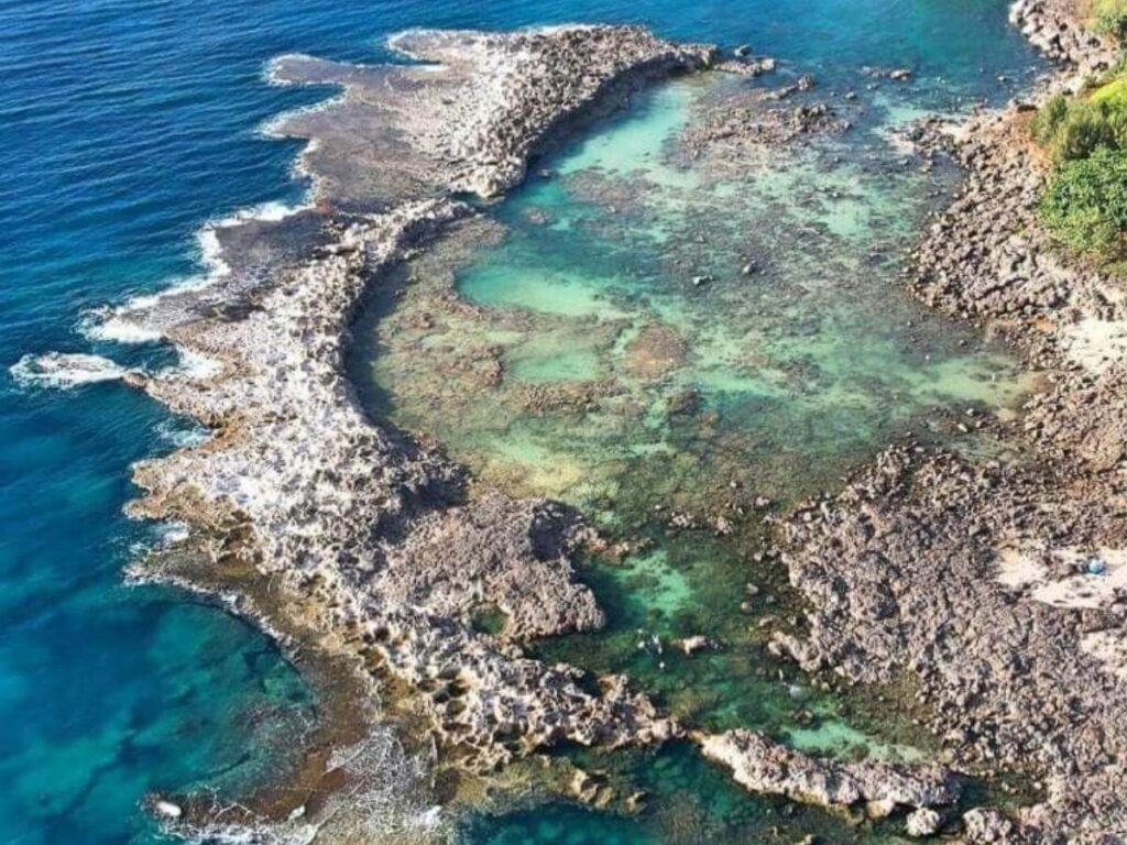 Towering sea cliffs rising from the ocean on Molokai’s north shore