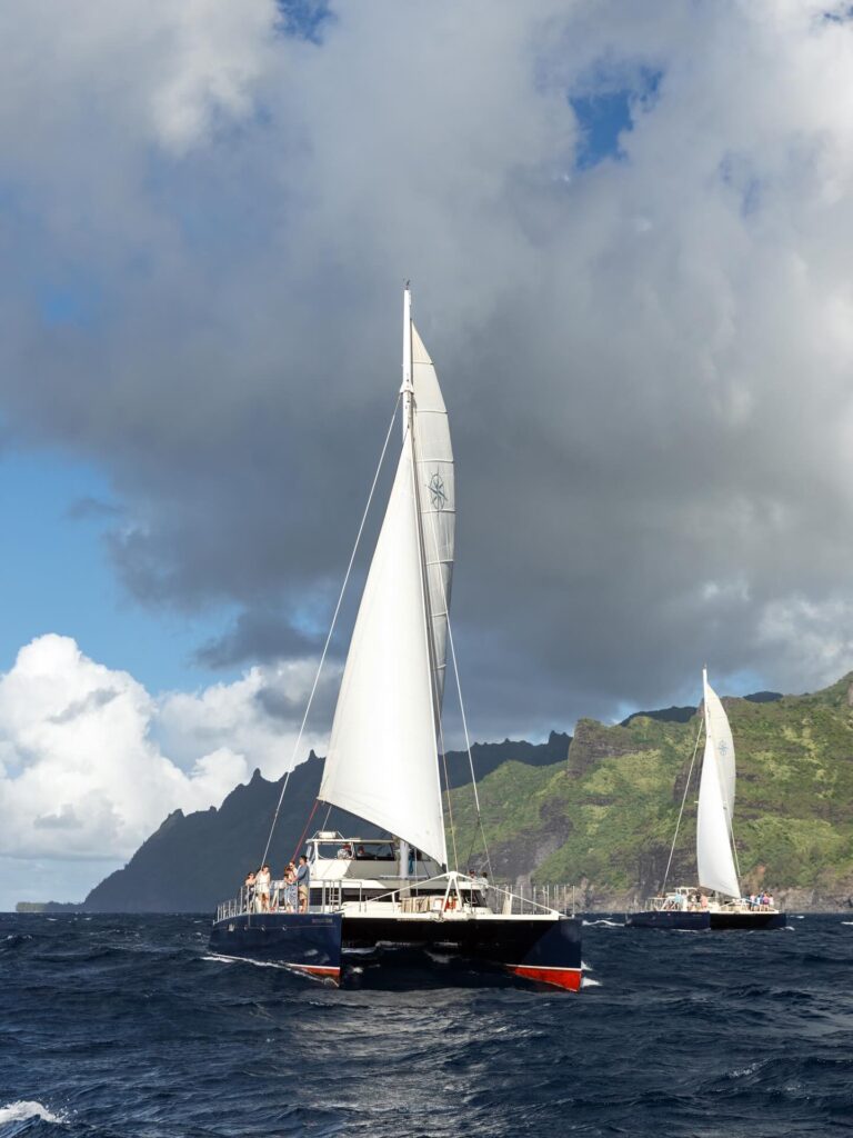 Boat tour passing the dramatic cliffs of the Na Pali Coast on Kauai