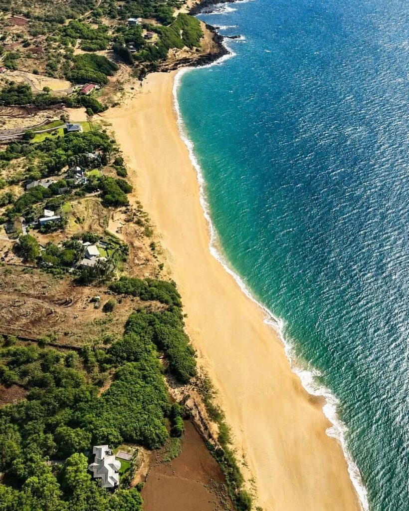 Wide sandy shoreline at Papohaku Beach on Molokai during the afternoon